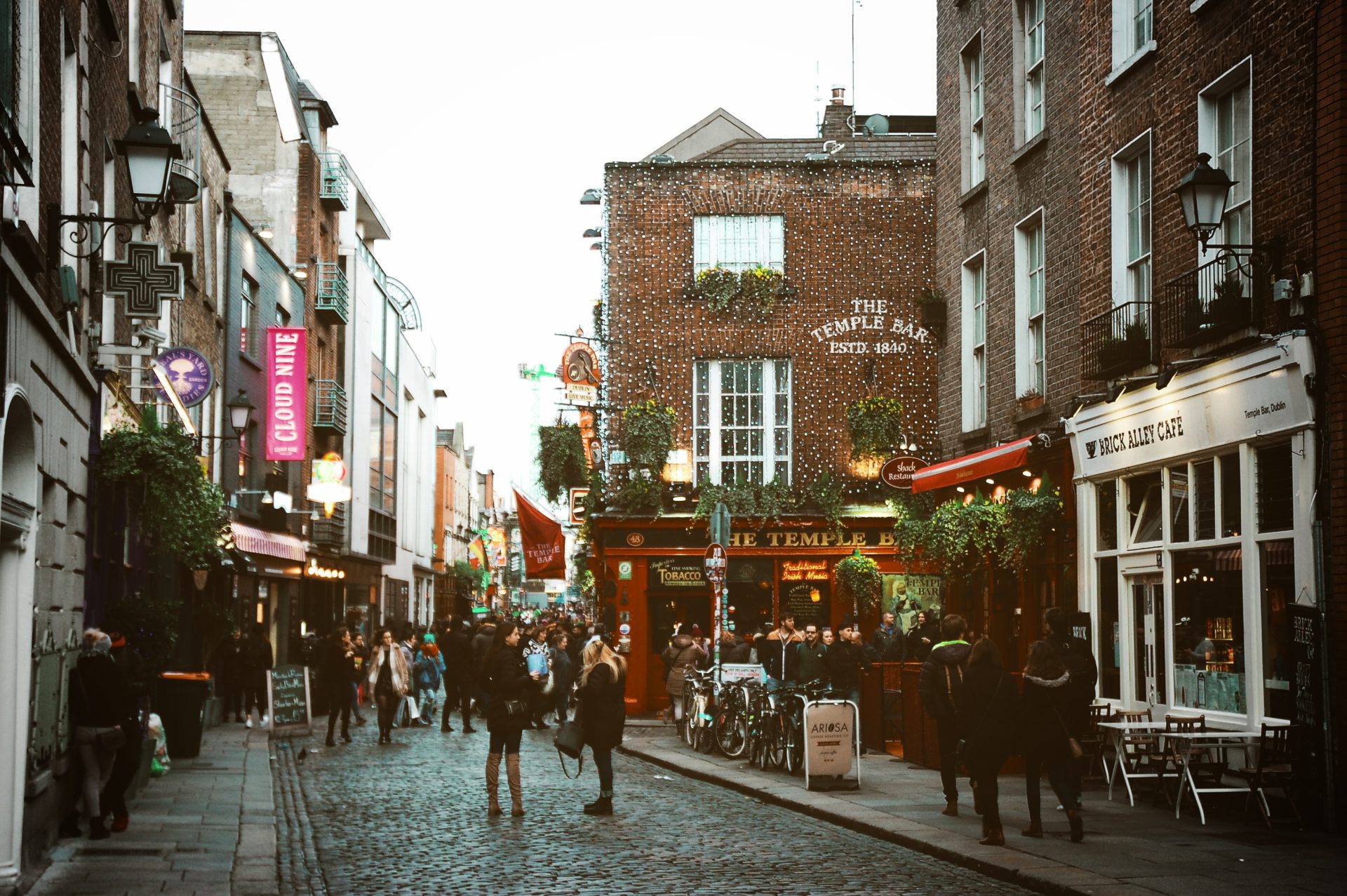 A street in Temple Bar, Dublin with pubs and flowers. 
